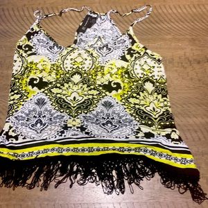 This is a tank top that is yellow black and white it has a cute fringe